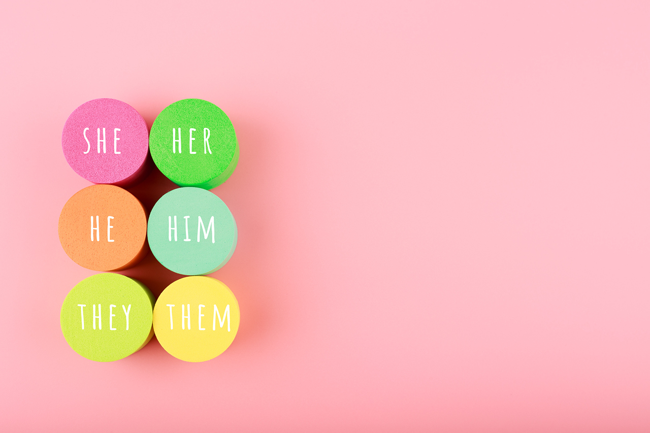Correct pronouns for different genders on light pink background with copy space. Concept of Lgbtq plus, transgender and bigender tolerance, respect and equal rights